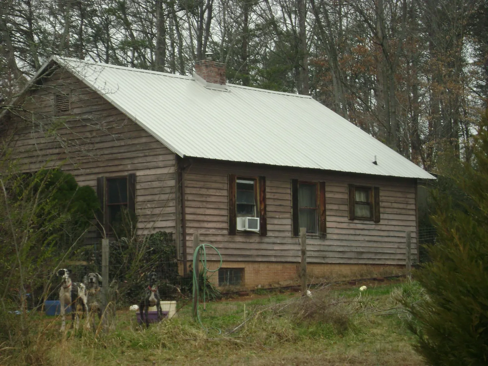 White metal roof on an old wood sided farmhouse, from a Metal Roof Installation job in Danielsville